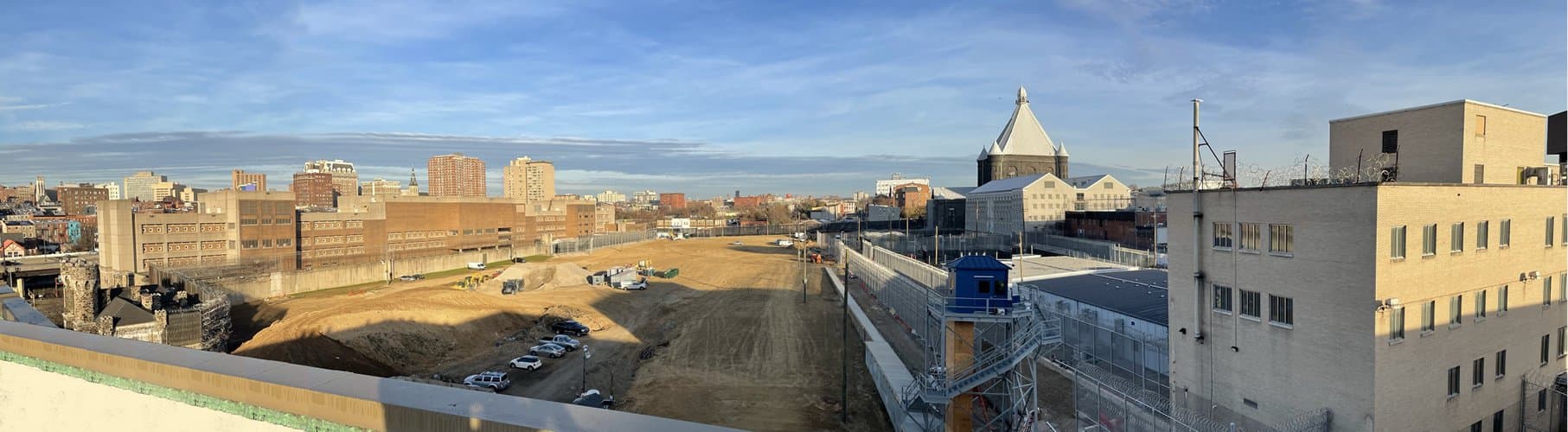 The cleared project site in Baltimore with the Maryland Penitentiary dome visible